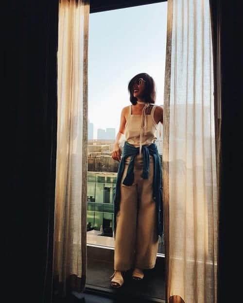 Liz Uy wearing all white and a chambray shirt