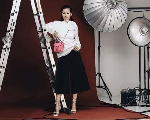 Liz Uy in white sweater and black culottes