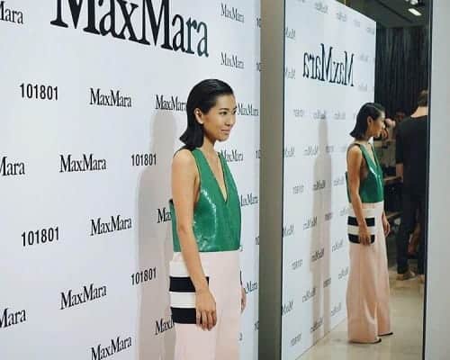 Liz Uy wearing a green sleeveless v-neck and pink palazzo pants