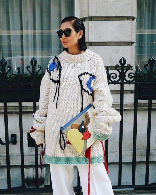 Liz Uy wearing a white knit sweater and palazzo pants