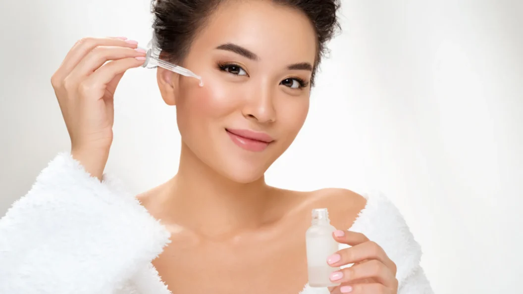 Woman using vitamin C serum